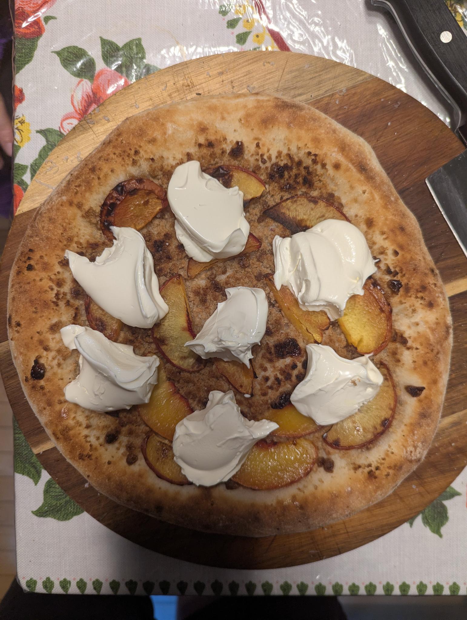 peach pizza with mascarpone a new york style pizza crust with a bed of streusel, topped with peaches and mascarpone